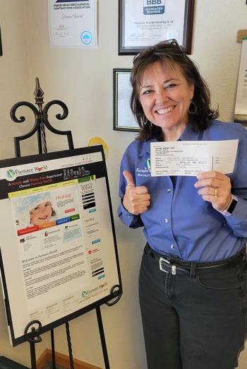 Photo of Furnace World leader Lisa Coffy smiling proudly in their Monument office